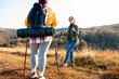 © Zoran Zeremski - Two smiling woman hiking at top of the hill at meadow.