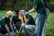 © Zamrznuti tonovi - Group of volunteers planting a tree in the park