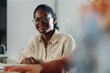 © Zamrznuti tonovi - Young black woman smiling during business meeting in modern office