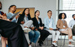 © Jacob Lund - Joyful team in an office setting networking and smiling during a casual meeting