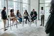 © Jacob Lund - Diverse professionals engaging in a panel discussion at a corporate event, sharing insights and expertise in a modern conference room setting.