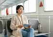 © Anna - Woman enjoys relaxing ferry ride with a book. Travel and leisure concepts.