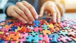 © Johannes - Color photo of a person assembling a puzzle, focused expression with colorful pieces spread out, warm indoor lighting
