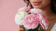 © Ice Cream Paradise - A close-up of a woman holding a bouquet of pink and white flowers against a soft pink background. The woman's face is partially visible, with her lips slightly parted and her gaze directed downwards