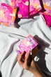 © Wirestock - Colorful sanitary pad package in hand