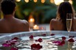 © YouraPechkin - Romantic evening in a hot tub with champagne and rose petals during sunset
