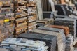 © juliars - Various stacks of tiles and wooden planks are neatly arranged, showcasing diverse materials and colors in a warehouse or showroom environment