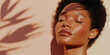 © Elena - Beautiful black woman with clean face and glowy skin, natural light with leaf shadows