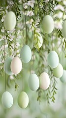 Wall Mural - Soft pastel easter eggs hang gracefully from willow branches against a muted white background, creating a serene and festive decoration perfect for spring celebrations