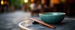 © Ghiska - Teal Bowl and Chopsticks on Rustic Table