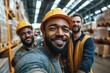 © Bojan - Smiling construction workers pose for a selfie in a busy warehouse during the day