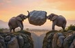 © VALERIY - Cohesive teamwork, the key to a successful business.  Two elephants lifting a big stone symbolize team unity - a metaphor.