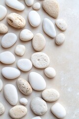 Poster - Smooth white and beige stones are scattered on a calming beige surface, illuminated by soft natural light, creating a peaceful atmosphere with plenty of space for additional text