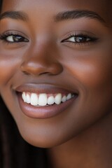 Wall Mural - African American woman with white teeth, looking at the camera and smiling broadly.