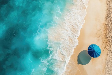 A tropical beach scene with a blue sun umbrella on the sandy shore. The ocean is turquoise and there are small waves near the shoreline.