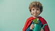 © Oleksandr Kozak - Child superhero holding a watering can with a small plant in a pastel setting