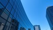 © PomPam - Modern Glass Skyscraper, Urban Architecture, Blue Sky, AI Photo