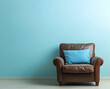 © Asif - A simple leather armchair with a blue cushion on the right side of an empty wall