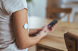 © Dragana Gordic - Person Monitoring Glucose Levels Using Modern Technology at Home