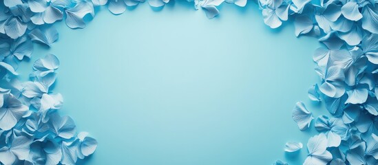 Wall Mural - delicate blue flower petals framing a calm turquoise gradient background with ample copy space for e