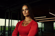 © Sergio - Strong woman posing confidently in modern gym during afternoon workout session