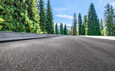 Wall Mural - Empty asphalt road with forest and mountain background at day