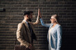 © Zamrznuti tonovi - Two happy business people giving high five celebrating success