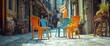 © Nas - Colorful plastic chairs sit empty on a cobblestone street in a quaint European town.
