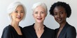 © mashimara - Empowered Women: Three elegant women of diverse ethnicities and ages stand shoulder to shoulder, radiating confidence and strength in a powerful portrait.
