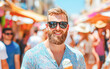 © Kowit - Summer fun man enjoying ice cream in colorful market outdoor vibrant