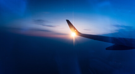 Wall Mural - wing at sunset through the window