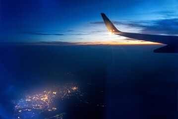 Wall Mural - wing at sunset through the window