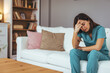 © Dragana Gordic - Tired Healthcare Worker Resting on Couch in Comfortable Home Environment