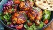 © วรรณภา มะโนศรี - A vibrant plate of hot tandoori chicken with a golden, crispy exterior, served with fresh salad and naan.