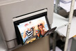 © New Africa - Modern printer with colorful photo indoors, closeup
