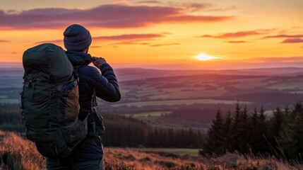 Wall Mural - Traveler admires the stunning sunset from a mountain viewpoint, surrounded by natures beauty and vast landscapes. Generative AI