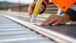 © DigitalSpace - A closeup of a workers hands applying adhesive to a composite material used in renewable infrastructure showcasing the precision and care involved in the process.