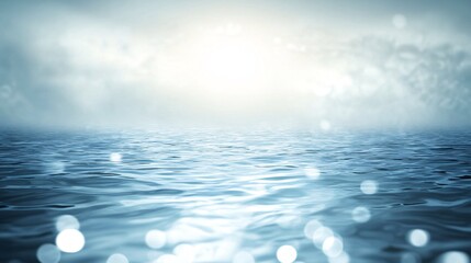 Wall Mural - A serene view of a tranquil ocean with soft waves reflecting shimmering light and a foggy horizon.
