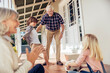 © Marko Geber - Grandparents and grandchildren playing with soccer ball on the porch