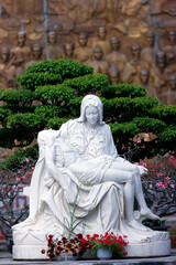 Wall Mural - Basilica of Our Lady of La Vang. Blessed Mother Mary holding Dead body of Jesus Christ statue. Pieta.  Marble statue.  Vietnam.