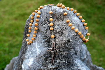 Wall Mural - Rosary on a rock. Symbol of strength and eternity. Catholic church. .