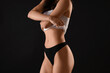 © Pixel-Shot - Pretty young woman in underwear on black background