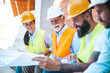 © Dragana Gordic - Team of Architects Reviewing Construction Plans on a Building Site