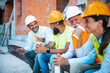© Dragana Gordic - Construction Workers on Coffee Break Smiling and Conversing at Job Site