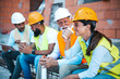 © Dragana Gordic - Group of Builders Relaxing with Coffee During Work Break at Construction Site