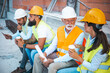 © Dragana Gordic - Construction Workers Having a Break at a Worksite, Chatting and Relaxing