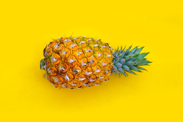 Wall Mural - Fresh pineapple on yellow background.