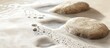 © STwul - Two beige stones resting on a foamy surface.