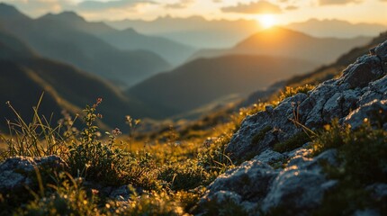 Fototapete - serene mountain landscape during sunset, with vibrant green grass and rocks in the foreground and the sun setting in the background, creating a warm and peaceful atmosphere.