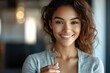 © k - Smiling Woman Realtor Holding Keys in Modern Office Confidently Offering Deal to Client